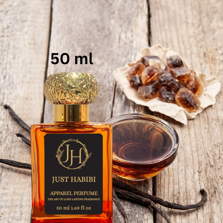 Just Habibi™ perfume bottle close up with vanilla beans and honey on a wooden surface. Fruity and floral fragrance