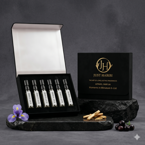 Set of Just Habibi perfume samples on a dark surface with a gray background