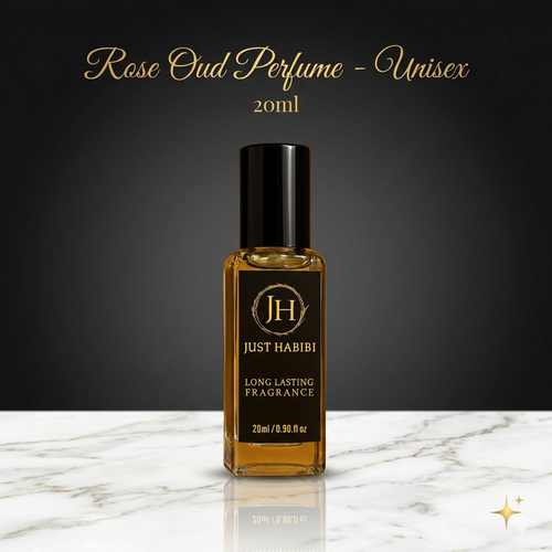 Rose Oud perfume bottle by Just Habibi on a marble surface with a dark background